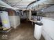 A utilitarian basement space featuring water heater, pipes, and concrete flooring, ready for necessary updates or improvements at 907 W 14Th St, Muncie, IN 47302