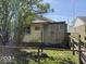 The side of the house features a unique wooden fence and ramp leading to the entrance at 907 W 14Th St, Muncie, IN 47302