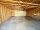 Spacious garage interior with unfinished walls, concrete floor, and an overhead door at 907 W 14Th St, Muncie, IN 47302