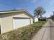 Exterior view of the detached garage with a white garage door and a side access door at 907 W 14Th St, Muncie, IN 47302