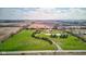 Expansive aerial view of a well-maintained home with a private pond and tree-lined driveway on acres of land at 9377 N 500 W, McCordsville, IN 46055