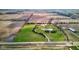 Aerial view of estate featuring lush lawn, private pond, and long driveway amid vast fields at 9377 N 500 W, McCordsville, IN 46055