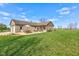 Large backyard with wood and brick home featuring a patio set and large lawn at 9377 N 500 W, McCordsville, IN 46055