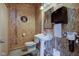 Small, rustic bathroom with sink, toilet, and NAPA-themed decor at 9377 N 500 W, McCordsville, IN 46055
