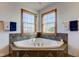 Serene bathroom corner features a large soaking tub with tiled accents and dual windows at 9377 N 500 W, McCordsville, IN 46055