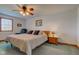 Cozy bedroom features a ceiling fan, a comfortable bed, and soft natural lighting at 9377 N 500 W, McCordsville, IN 46055