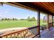 Relaxing covered porch with a view of the expansive green lawn and a tranquil pond at 9377 N 500 W, McCordsville, IN 46055