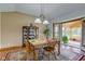 Inviting dining area featuring wood floors, classic china cabinet, and sunroom access with natural light at 9377 N 500 W, McCordsville, IN 46055