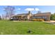 Inviting brick home with well-manicured lawn, mature landscaping, and a cozy front porch at 9377 N 500 W, McCordsville, IN 46055