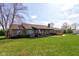 Beautiful brick home with a lush green lawn, mature trees, and a welcoming front porch at 9377 N 500 W, McCordsville, IN 46055