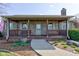Charming covered porch with brick detailing, a seating bench, and a patterned welcome mat at 9377 N 500 W, McCordsville, IN 46055