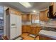 Bright kitchen featuring wooden cabinets, white refrigerator, and a view of the outdoor patio at 9377 N 500 W, McCordsville, IN 46055