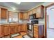 Cozy kitchen featuring wood cabinets, stainless steel appliances, and hardwood floors at 9377 N 500 W, McCordsville, IN 46055