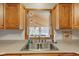 Bright kitchen featuring a stainless steel sink with a view to the deck at 9377 N 500 W, McCordsville, IN 46055