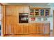 Kitchen cabinetry showcasing wooden cabinets and oven with glass doors and views into other rooms at 9377 N 500 W, McCordsville, IN 46055