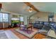 Inviting living room with vaulted ceilings, exposed beam, hardwood floors, and comfortable leather sectional at 9377 N 500 W, McCordsville, IN 46055