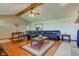 Open living room featuring hardwood floors, vaulted ceilings with wooden beam and large leather sectional at 9377 N 500 W, McCordsville, IN 46055