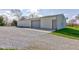 An exterior shot of the outbuilding showing both the drive in door and a walk in door at 9377 N 500 W, McCordsville, IN 46055