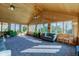 Inviting sunroom with wood interior, plush carpeting, and plenty of natural light from the surrounding windows at 9377 N 500 W, McCordsville, IN 46055