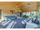 Comfortable sunroom with wood walls and ceilings, plush carpeting, and ample natural light from many windows at 9377 N 500 W, McCordsville, IN 46055