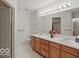 Bathroom featuring double sinks, wood cabinets and lots of natural light at 1108 Nanwich Ct, Indianapolis, IN 46217