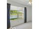 Bedroom with a large window providing a view of the lake and surrounding greenery at 1108 Nanwich Ct, Indianapolis, IN 46217