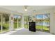 This sunroom features beautiful views of the lake and landscaping through sliding glass doors at 1108 Nanwich Ct, Indianapolis, IN 46217
