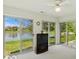 This sunroom features beautiful views of the lake and landscaping through sliding glass doors at 1108 Nanwich Ct, Indianapolis, IN 46217