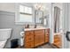 Traditional bathroom with wood paneling, window, and a stylish vanity at 1114 Pennsylvania St, Columbus, IN 47201