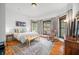 Serene bedroom with a large bed, rocking chair, and bright windows with wood trim at 1114 Pennsylvania St, Columbus, IN 47201