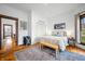 Bright bedroom with a bed, bench, area rug, and entryway to other rooms at 1114 Pennsylvania St, Columbus, IN 47201