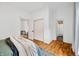 Comfortable bedroom with wood floors, closet, and doorway to the bathroom and adjacent room at 1114 Pennsylvania St, Columbus, IN 47201