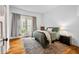 Sunlit bedroom with decorative rug, stylish chair, and plush bedding at 1114 Pennsylvania St, Columbus, IN 47201