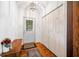 Bright entryway with hardwood floors, a decorative light fixture, a white closet door and an accent table at 1114 Pennsylvania St, Columbus, IN 47201
