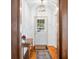 Inviting entryway featuring hardwood floors, a stylish light fixture, and an elegant accent table with floral decor at 1114 Pennsylvania St, Columbus, IN 47201