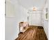 Bright entryway with warm wood floors, a storage table, closet, and natural light from the window at 1114 Pennsylvania St, Columbus, IN 47201