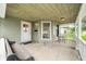 Relaxing front porch featuring a bench, chairs, and stylish overhead lighting, perfect for outdoor enjoyment at 1114 Pennsylvania St, Columbus, IN 47201
