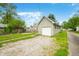 Detached garage, with gravel drive and chain-link fence, provides space to store vehicles or equipment at 1114 Pennsylvania St, Columbus, IN 47201