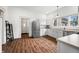 Open kitchen boasts stainless appliances, new white cabinets, and durable floors with a convenient layout at 1114 Pennsylvania St, Columbus, IN 47201
