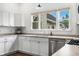 Updated kitchen featuring bright white cabinetry, stainless steel appliances, and a sunny window above the sink at 1114 Pennsylvania St, Columbus, IN 47201