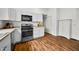 Efficient kitchen design with stainless steel appliances, ample storage in the white cabinets, and durable flooring at 1114 Pennsylvania St, Columbus, IN 47201