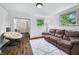 Inviting living room with large windows, comfortable seating, and an open doorway at 1114 Pennsylvania St, Columbus, IN 47201