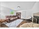 Cozy living room with a fireplace, plush seating, a bookshelf, and neutral decor at 1114 Pennsylvania St, Columbus, IN 47201