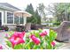 Inviting patio area featuring an umbrella-covered table, hot tub, and comfortable seating in a serene backyard setting at 11233 Rockingham Cir, Fishers, IN 46037