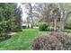 Green backyard with lush shrubs and mature trees, creating a serene and private outdoor space at 11233 Rockingham Cir, Fishers, IN 46037