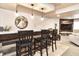 Finished basement bar with three stools, shiplap accent wall, and wood-look tile flooring at 11233 Rockingham Cir, Fishers, IN 46037
