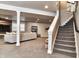 Finished basement features staircase, modern lighting, and a comfortable seating area at 11233 Rockingham Cir, Fishers, IN 46037