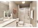 Neutral-toned bathroom with glass enclosed shower, single sink vanity, and chrome fixtures at 11233 Rockingham Cir, Fishers, IN 46037