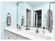 Bright bathroom features a double sink vanity, large mirror, and is decorated in light aqua blue at 11233 Rockingham Cir, Fishers, IN 46037