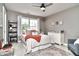 Comfortable bedroom with a ceiling fan, large window, cozy rug, and ample natural light at 11233 Rockingham Cir, Fishers, IN 46037